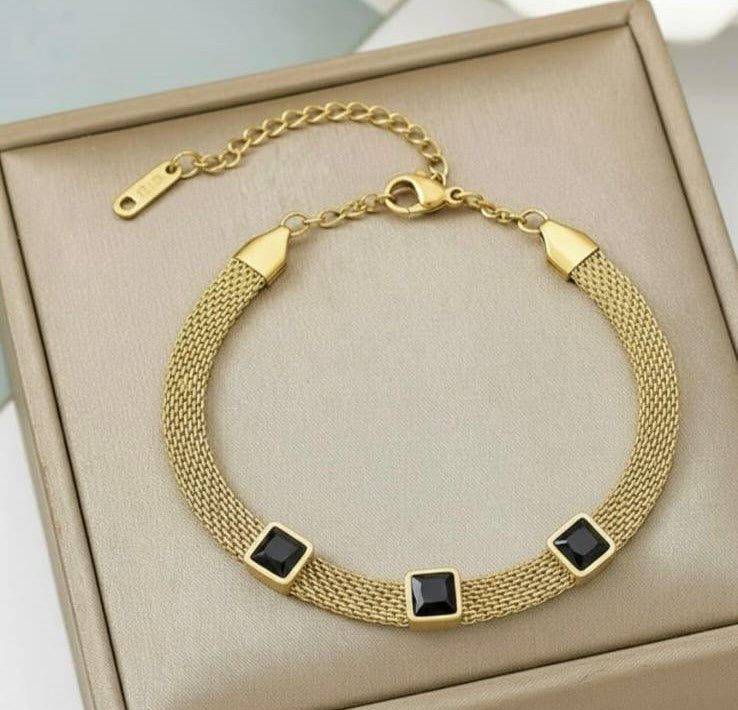 Gold stainless steel mesh bracelet with black square crystal stones.