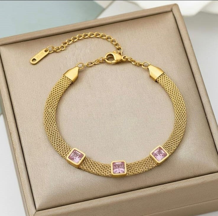 Gold stainless steel mesh bracelet with pink square crystal stones.