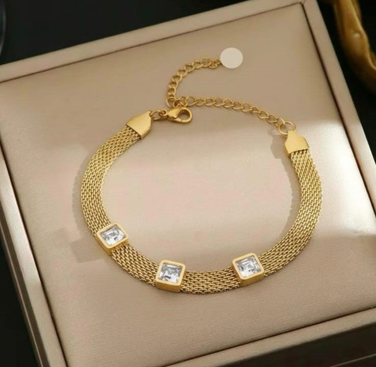 Gold stainless steel mesh bracelet with white square crystal stones.