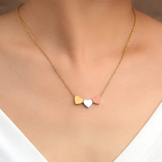 Necklace with heart-shaped charms on a plain background