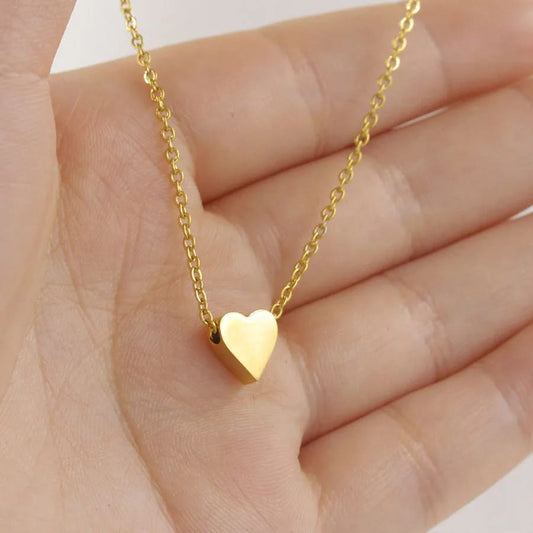 Minimalist gold heart pendant necklace on a delicate gold chain