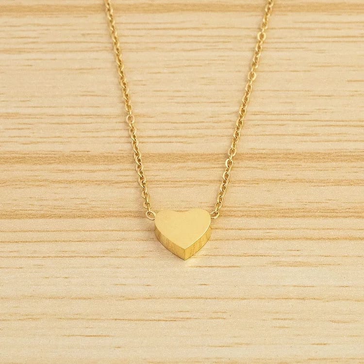 Minimalist gold heart pendant necklace on a delicate gold chain