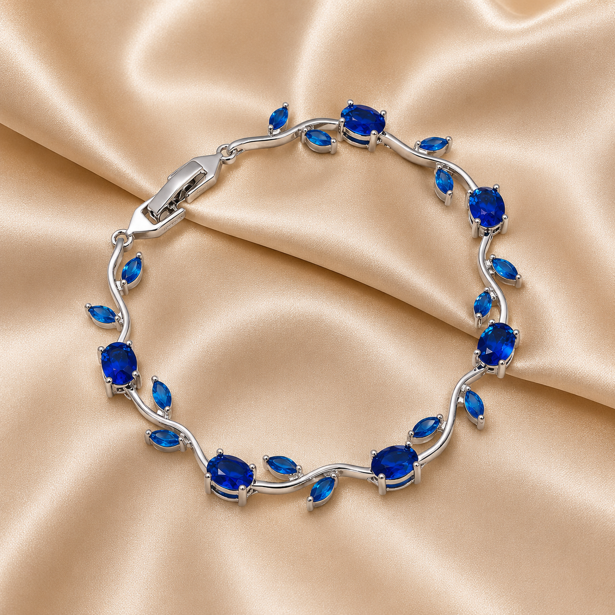 A silver-toned leaf-link bracelet with oval and marquise-cut deep blue gemstones, tulip bracelet