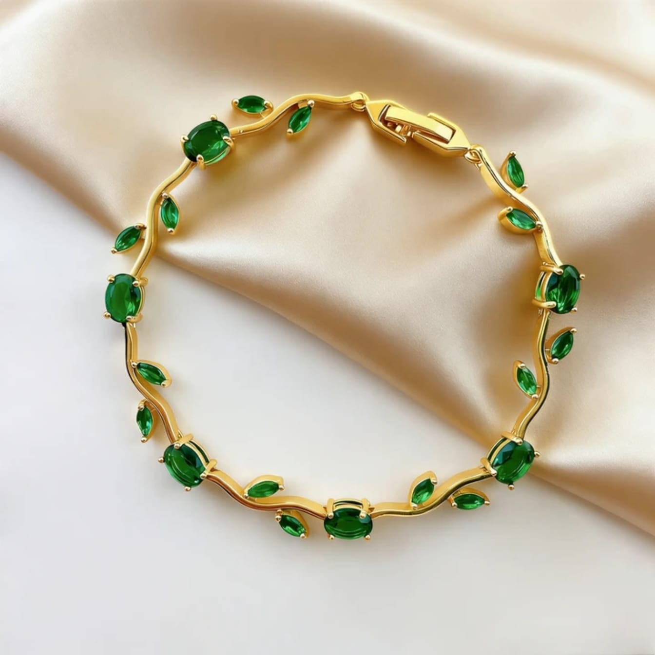 Gold bracelet with green gemstones 